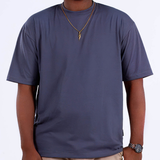 A person wearing a medium gray oversized t-shirt, front view